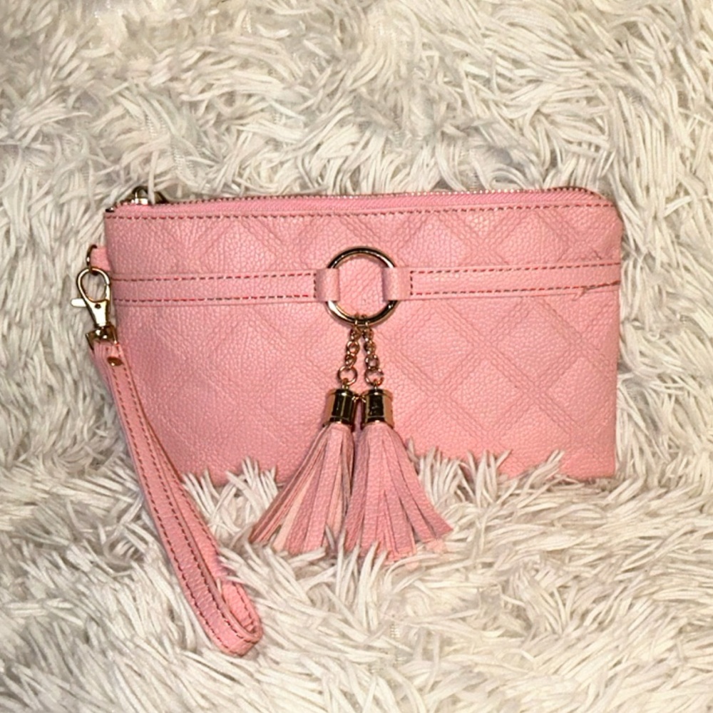 Pink faux leather wristlet with a gold zipper. Small zipper pocket in the back.